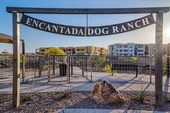A sign that reads "Encantada Dog Ranch" is displayed in front of a fenced area.