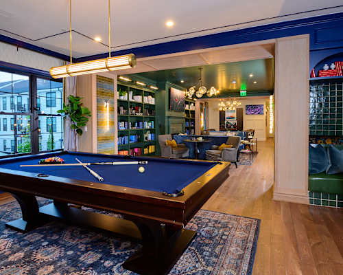 A pool table in a room with a view of the city.
