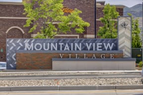 a sign for the mountain view veterinary clinic in front of a brick building