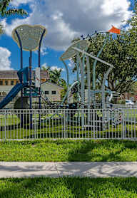 a playground at a park with a blue slide