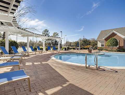 A tennis court with a green surface and white lines at Greenbrier Estates, Slidell, 70460