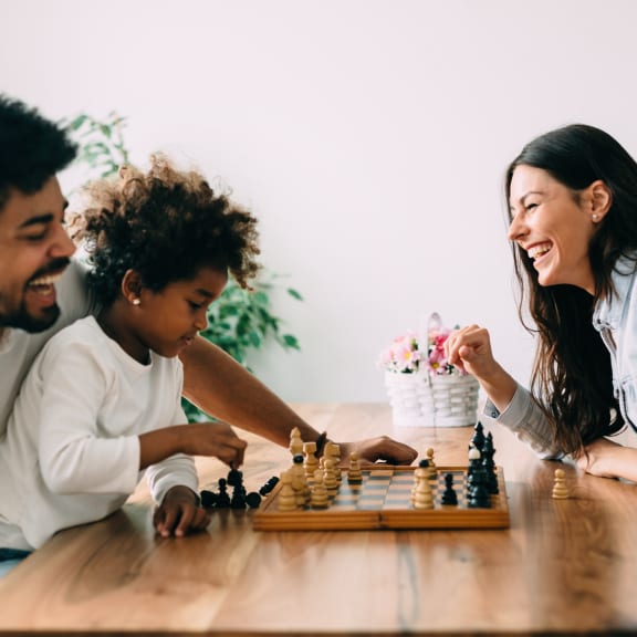 a family playing chess at a table