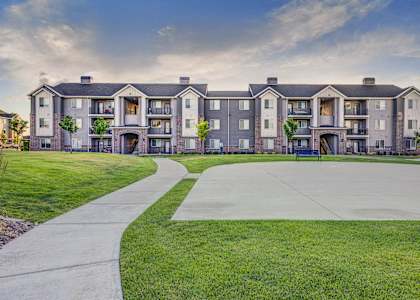 A large apartment complex with a walkway in front.