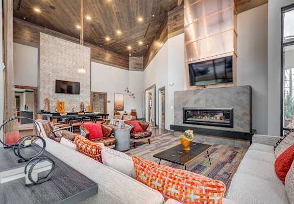 A modern living room with a fireplace and a television.