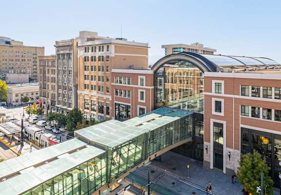 an overhead pedestrian bridge connects the two buildings