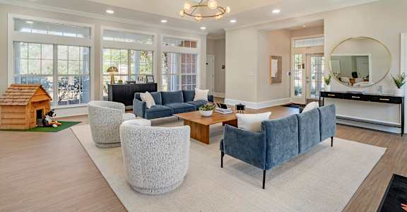 A living room with a grey sofa and a wooden coffee table.