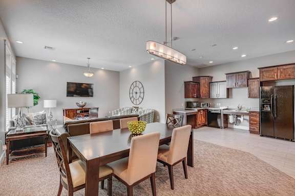 A modern dining room with a large table and chairs.