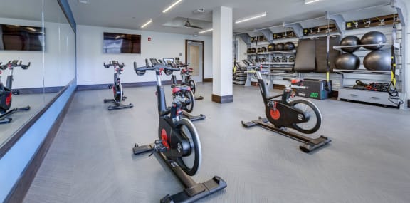 a gym with exercise bikes and other fitness equipment