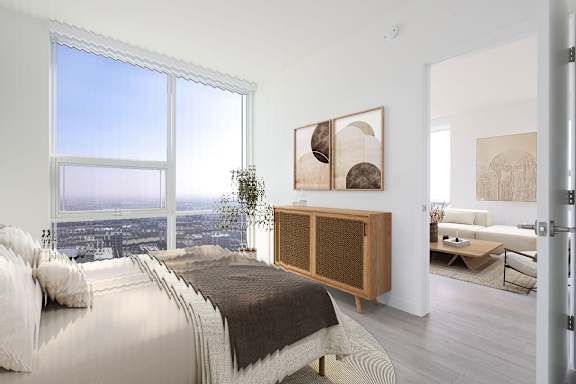 A bedroom with a large bed and a view of the city.