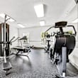 A gym with treadmills, exercise bikes, and weight machines.
