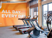 Thumbnail 39 of 40 - a row of treadmills in front of a wall with the words all day every day
