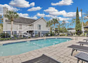 Thumbnail 33 of 47 - the preserve at ballantyne commons pool and patio area with tables and a building