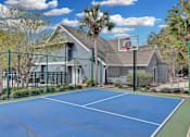 Thumbnail 41 of 47 - the backyard of a house with a tennis court and a basketball hoop