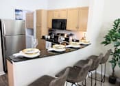 Thumbnail 4 of 18 - View of the kitchen in the model home at Harbour Breeze Apartments in Suffolk Virginia