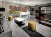 Thumbnail 14 of 27 - Seating area in clubhouse with couch, table, shelves