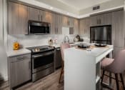 Thumbnail 17 of 27 - Kitchen with table and chair and steal appliances