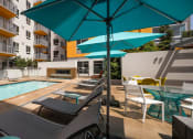 Thumbnail 2 of 27 - Lounge seating with umbrellas by pool