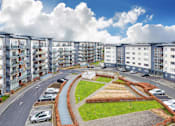 Thumbnail 4 of 5 - a view of an apartment complex with cars parked in front of it