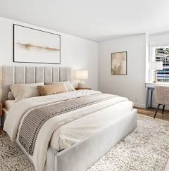 A grey headboard with a white pillow and a grey pillow case.