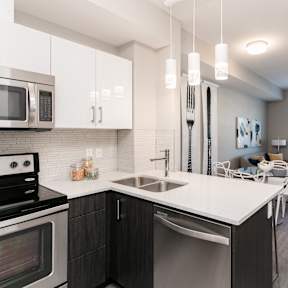 a kitchen and living room with a table and a tv