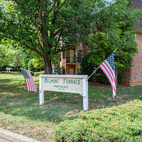 three flags are displayed in front of a church sign