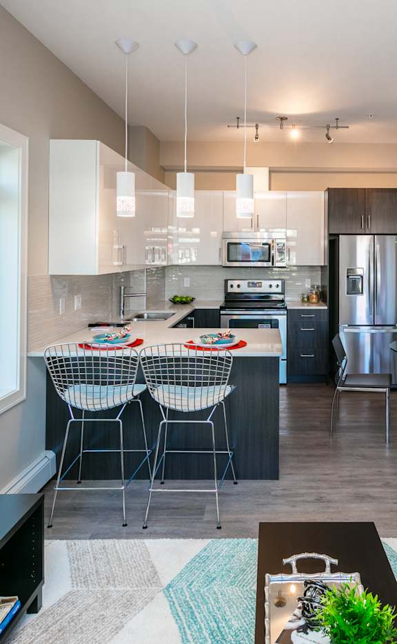 A modern kitchen with a dining table and chairs.
