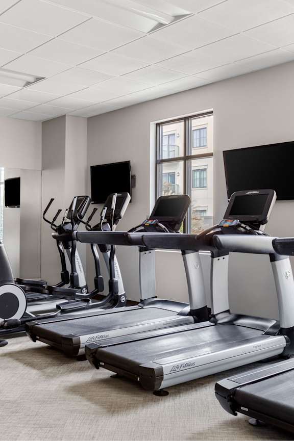 A gym with treadmills and exercise bikes.