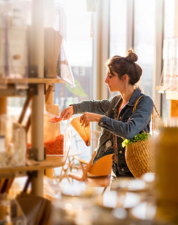 a woman holding shopping bags in a store