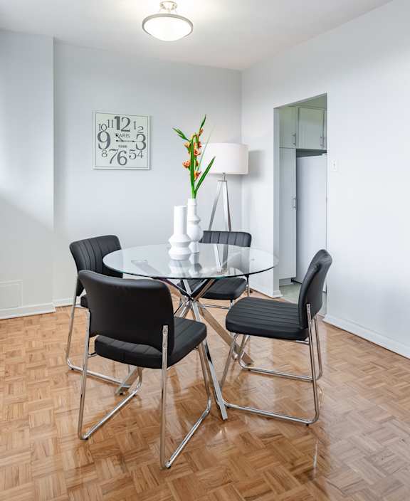A living room with a white couch and a dining table.