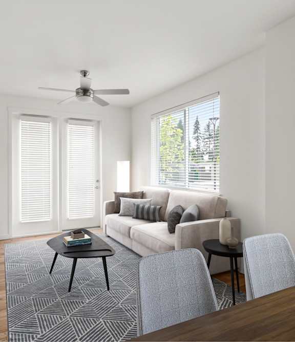A living room with a couch, a coffee table, and a television.