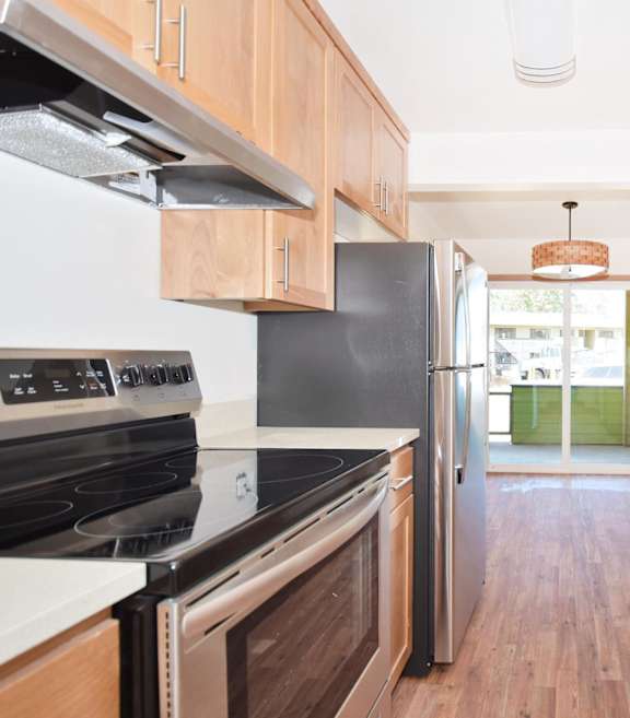 a kitchen with wooden cabinets and stainless steel appliances