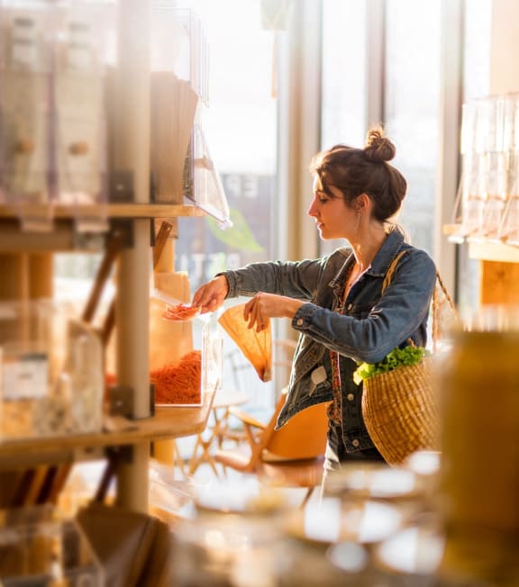 a woman working in a factory with jars of food