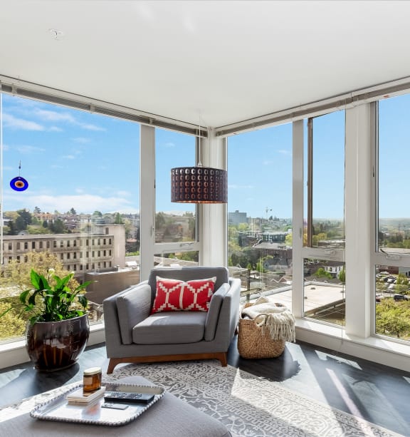 a living room with a large window and a view of a city at Cuvee, Seattle, WA, 98122
