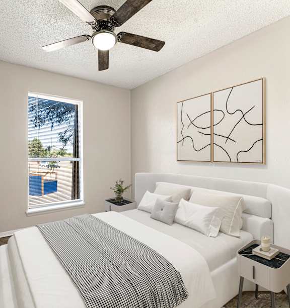 A bedroom with a large bed and a ceiling fan.