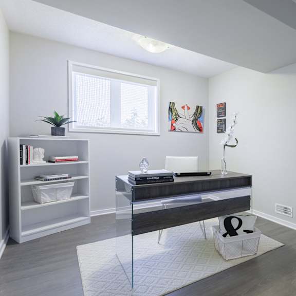 A room with a desk and a bookshelf.