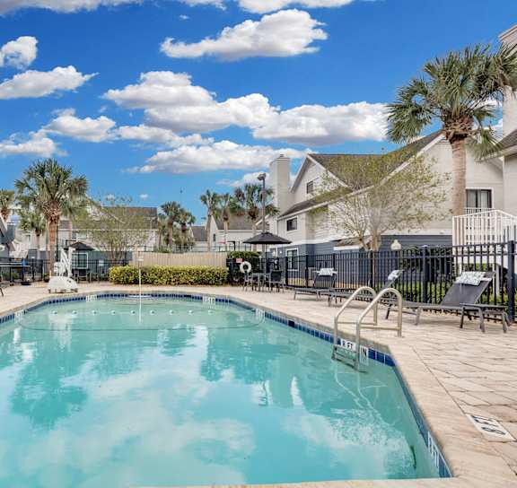 an aerial view of a swimming pool with umbrellas at AVIA Lofts on Liberty Ridge, Florida
