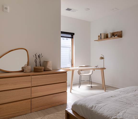 a bedroom with a bed and a desk with a chair