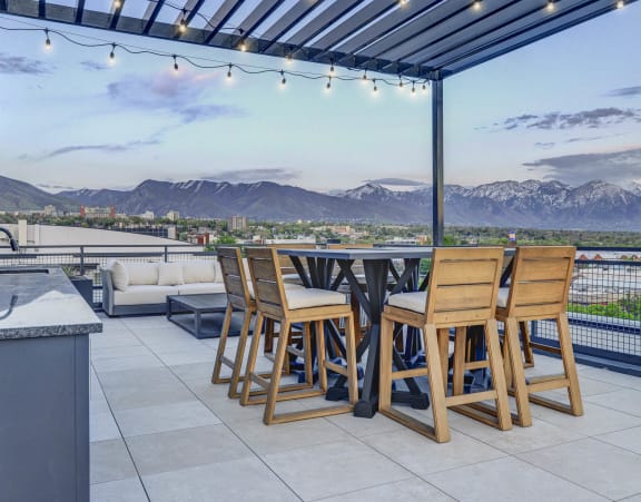 the patio has a view of the city and the mountains in the background