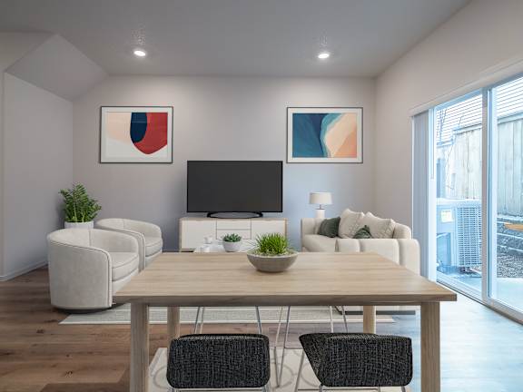 A modern living room with a wooden dining table and chairs.