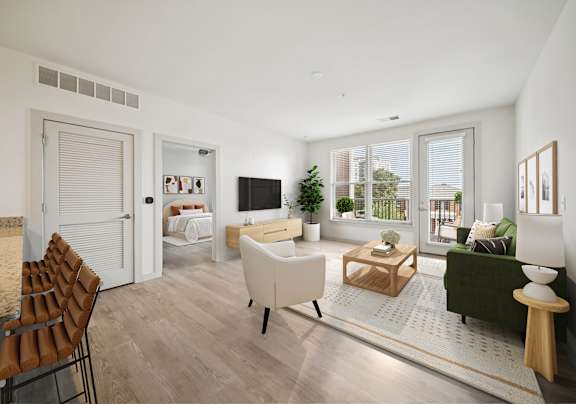 A modern living room with a white sofa and a wooden coffee table.