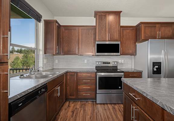 A kitchen with wooden cabinets and stainless steel appliances.