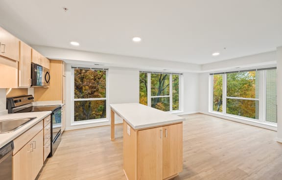 a kitchen with a large window and a table in the middle