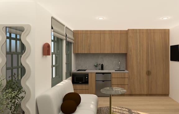 a living room with a green couch and a balcony