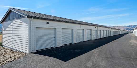 a row of garage doors on the side of a building  at Gateway Apartments, East Wenatchee ,Washington, 98802