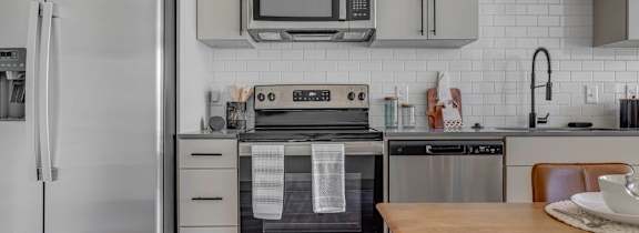 a kitchen with a white counter top and blue cabinets