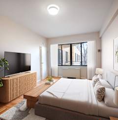 a living room with black furniture and a tv
