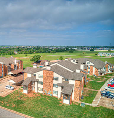 an aerial view of a neighborhood with houses and a parking lot