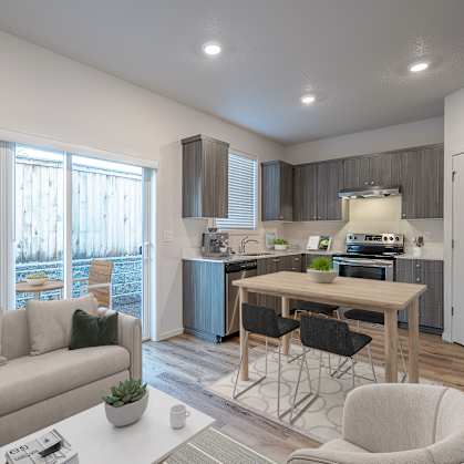 A modern kitchen and living room with a dining table and chairs.