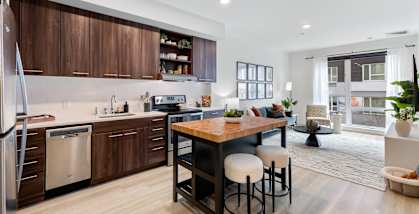 A modern kitchen with wooden cabinets and a large island.