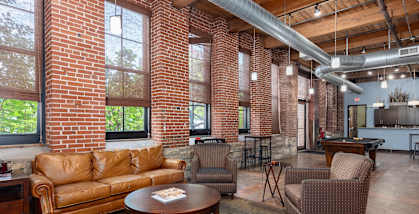 a living room with couches and chairs and a table